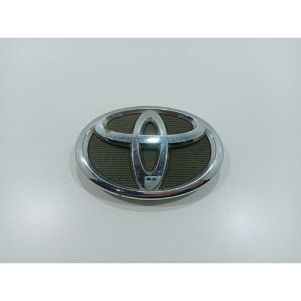 Emblema Parachoque Dianteiro Toyota Corolla 2009/2014 Orig